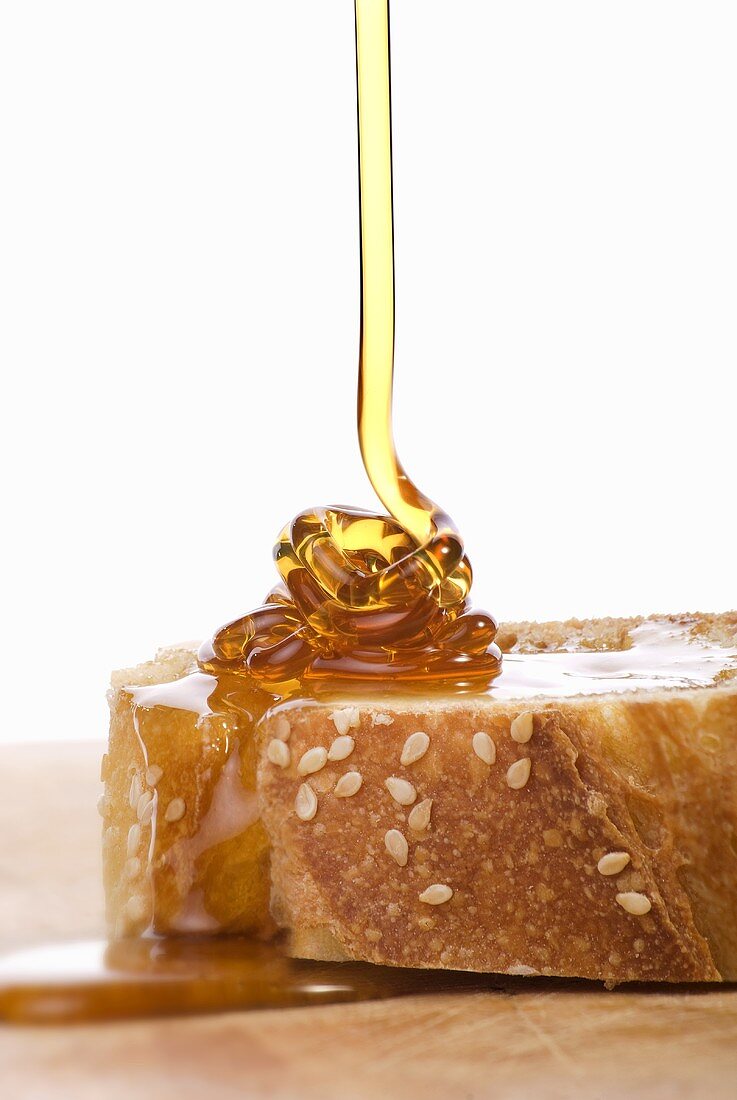 Honey running onto bread