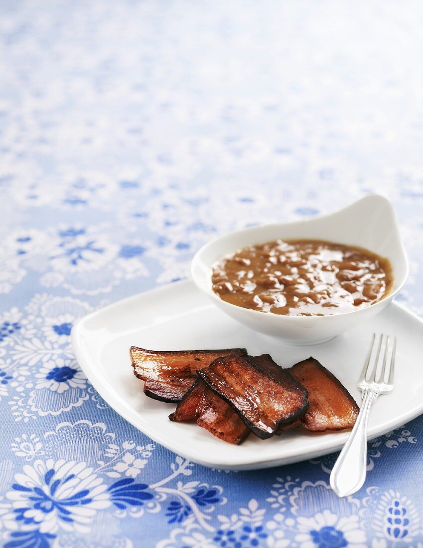 Fried bacon with brown beans