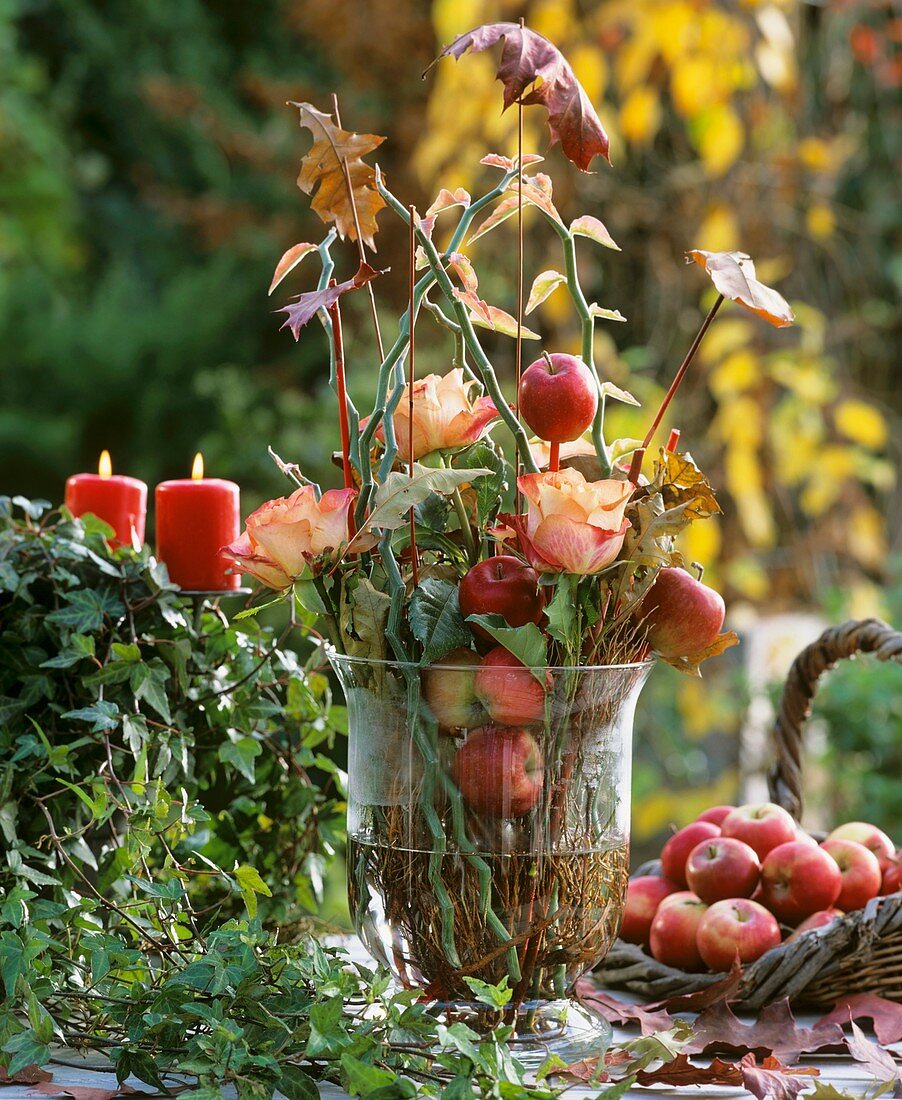 Glass with Perilepta branches, apples & leaves on sticks, rose