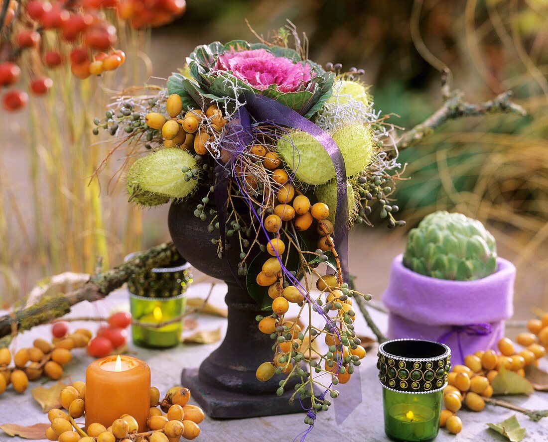 Arrangement of ornamental cabbage, silkweed fruits & dates
