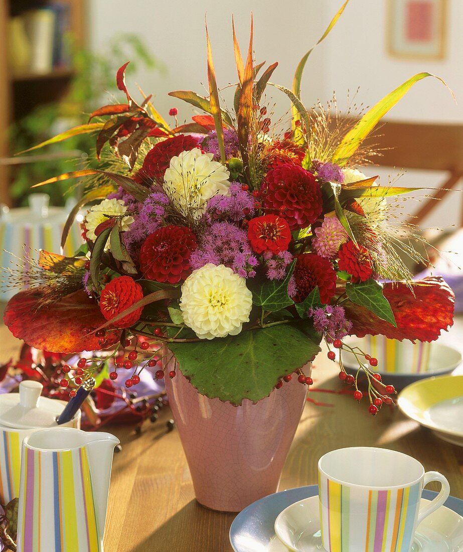 Autumn arrangement of dahlias, zinnias, Ageratum and rose hips