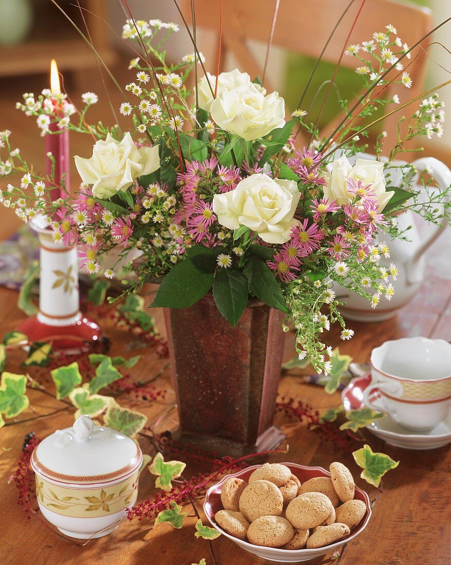 Autumnal arrangement of white roses, asters and grasses