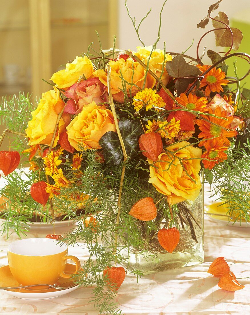 Arrangement of roses, Chinese lanterns & ornamental asparagus