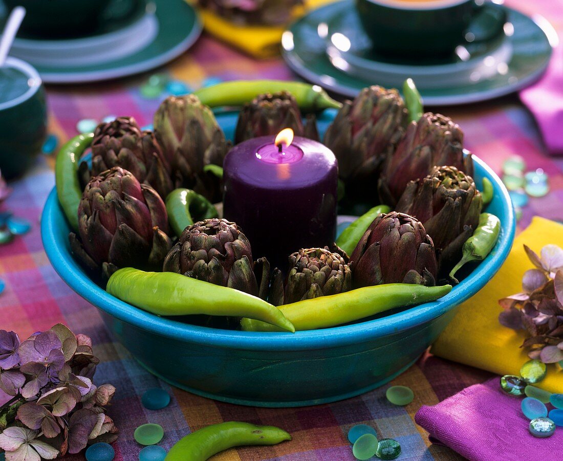 Table decoration with artichokes and chili peppers