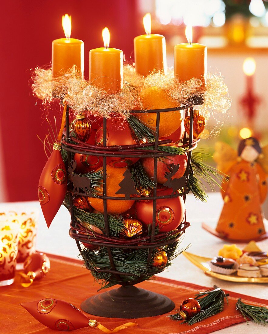 Advent wreath with tree ornaments, oranges and apples