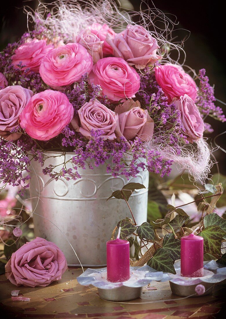 Arrangement of ranunculus, roses, sea lavender and sisal