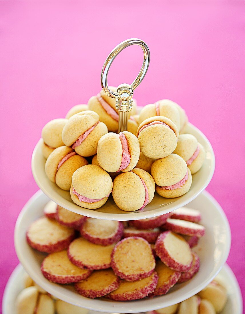 Small filled cakes and biscuits with pink sugared edges