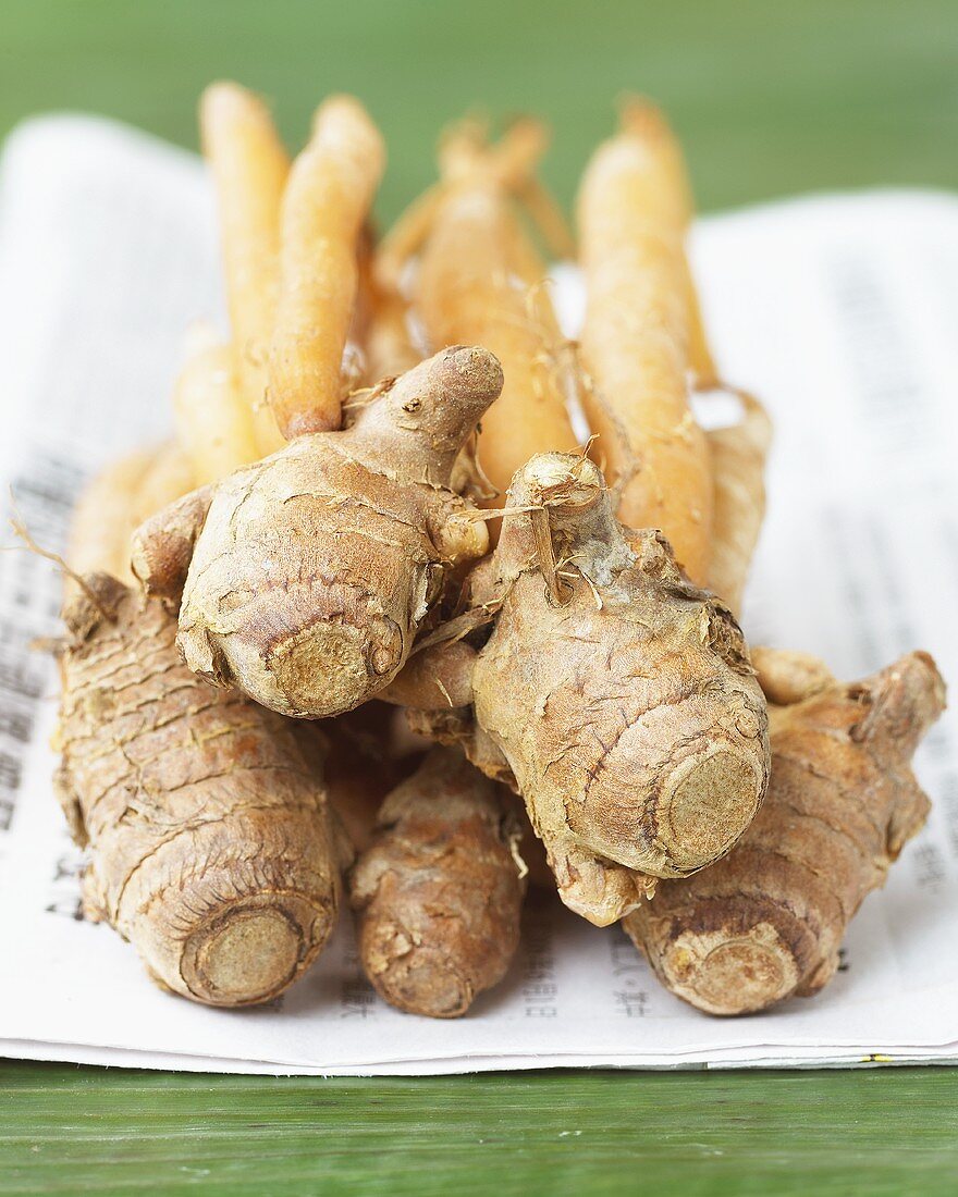 Turmeric roots on Asian newspaper