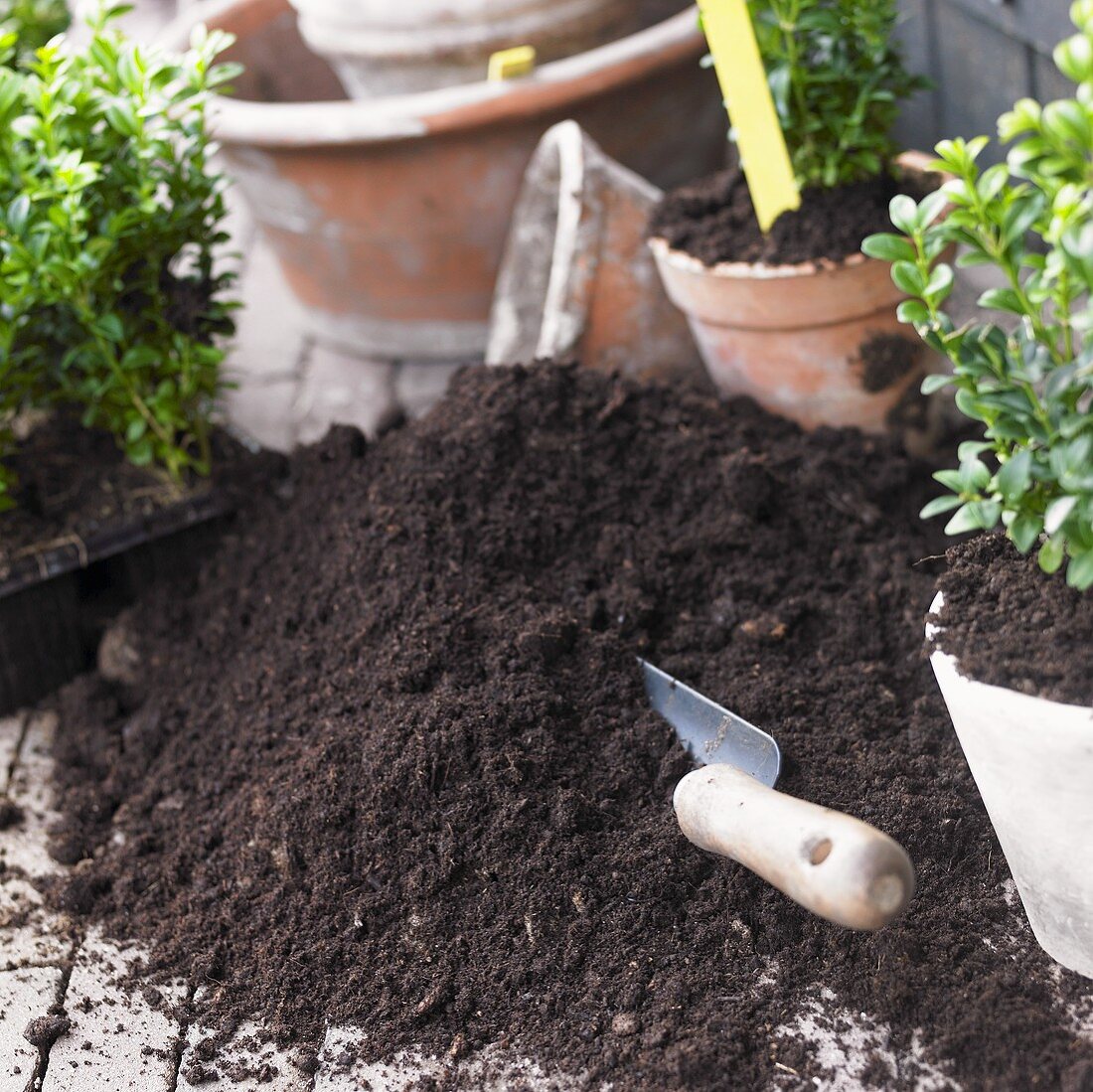 Garden soil with trowel, flowerpots