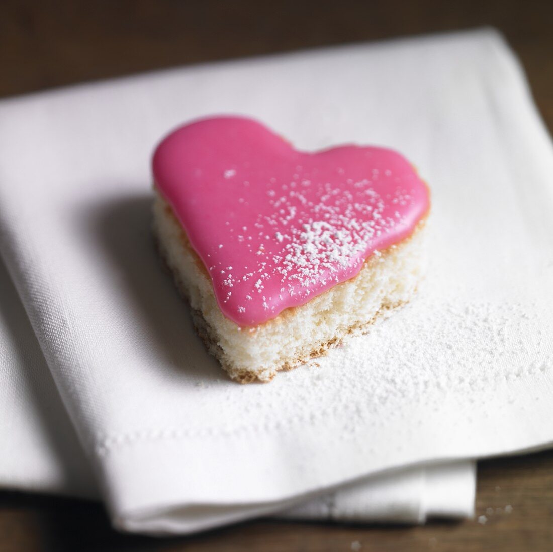 Heart-shaped petit four with pink icing