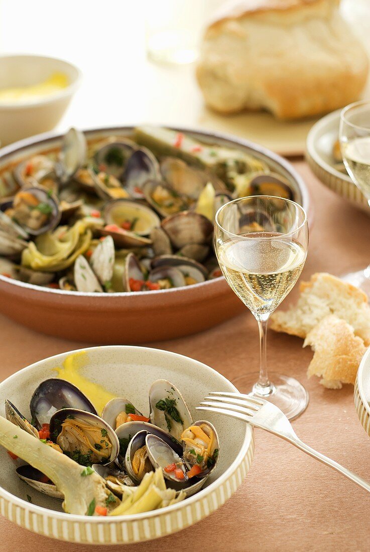 Shellfish and vegetables with bread and white wine