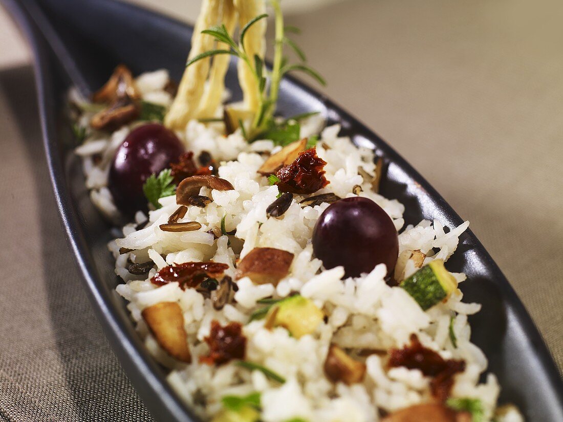 Rice dish with chestnut mushrooms, courgettes, black olives & dried tomatoes