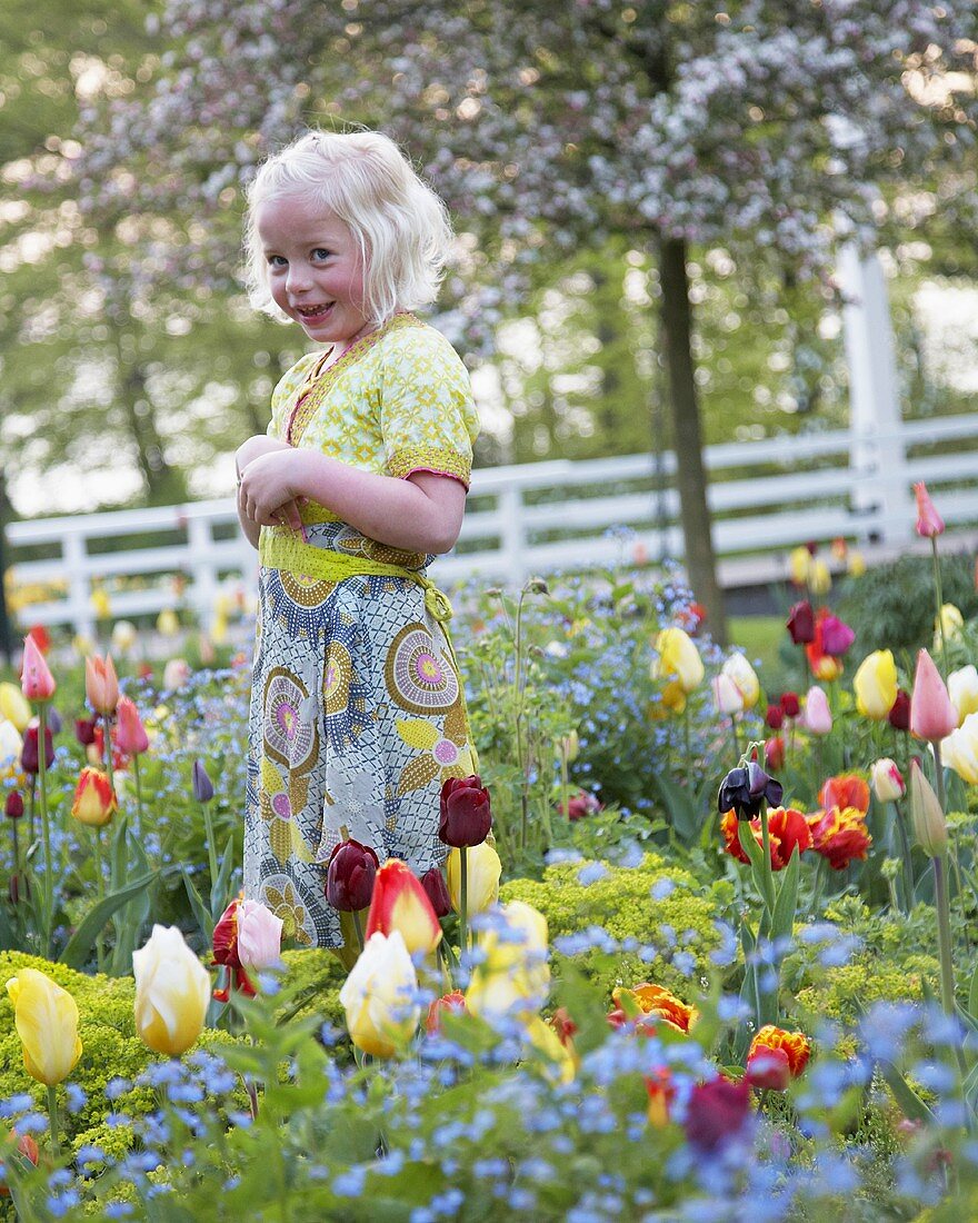 Blond girl in springtime garden