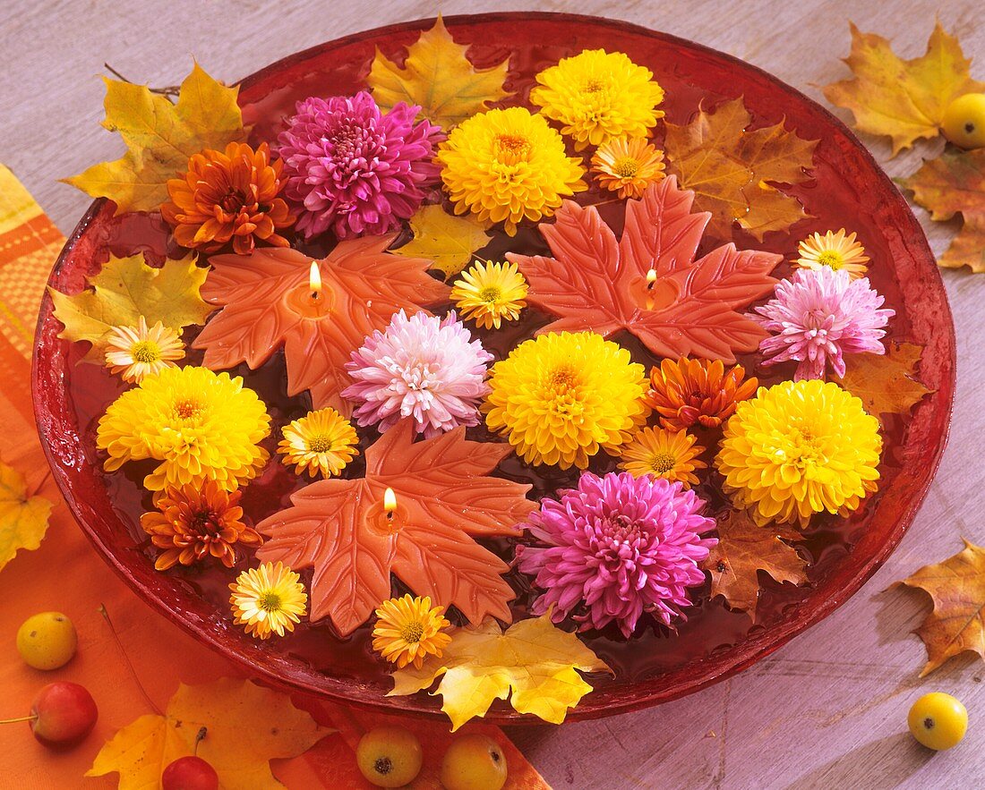 Bowl of floating candles and chrysanthemums