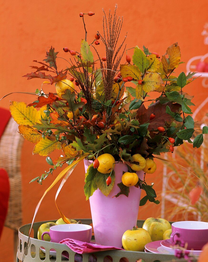 Autumn arrangement in pink vase: Cydonia (quince)