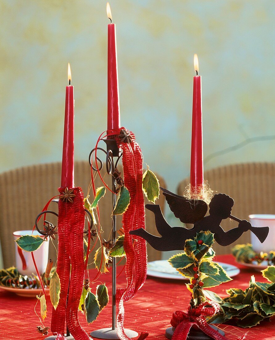 Candlestick decorated with holly leaves and berries