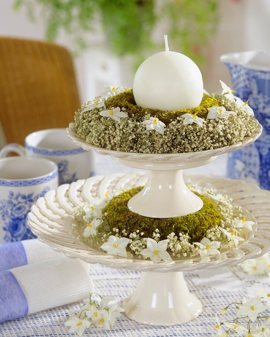 Tiered stand with moss ring and wreath of gypsophila