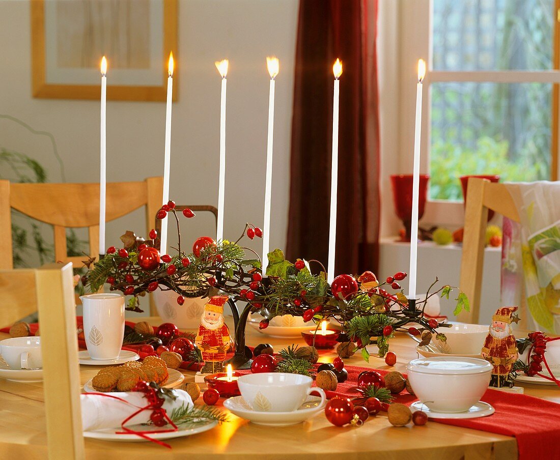 Festive table decoration with rose hips & nuts for Advent tea