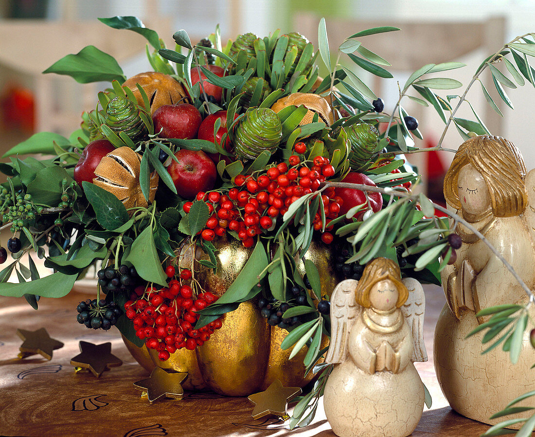 Winter arrangement of rowan, protea, ornamental apples, oranges