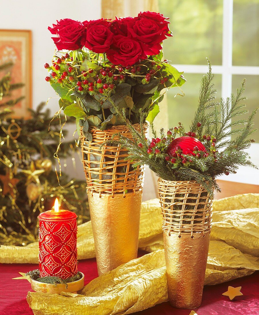 Arrangement of red roses, berries and cedar branches