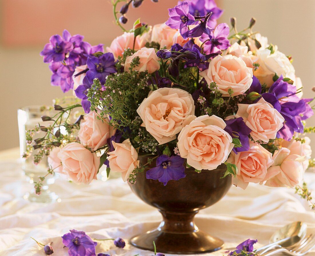 Arrangement of climbing roses, delphiniums and thyme