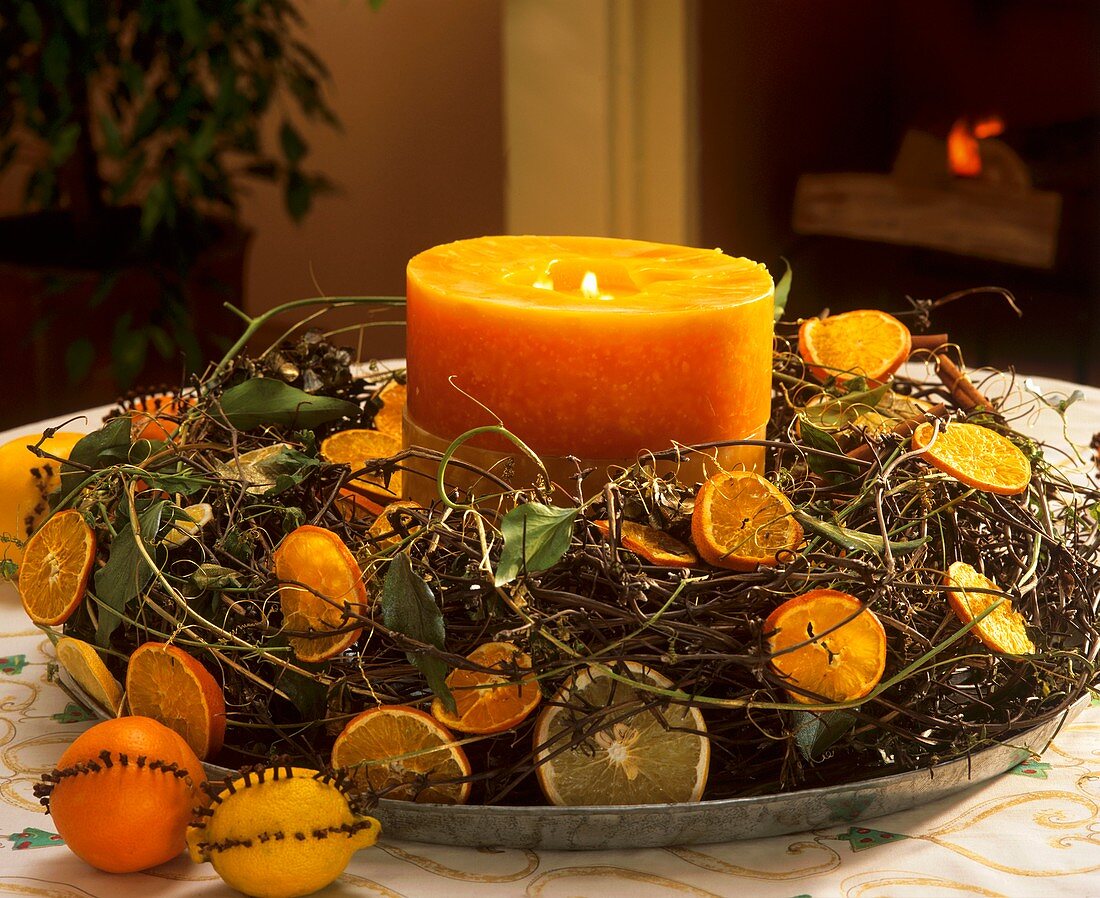Advent wreath with citrus fruit and orange candle