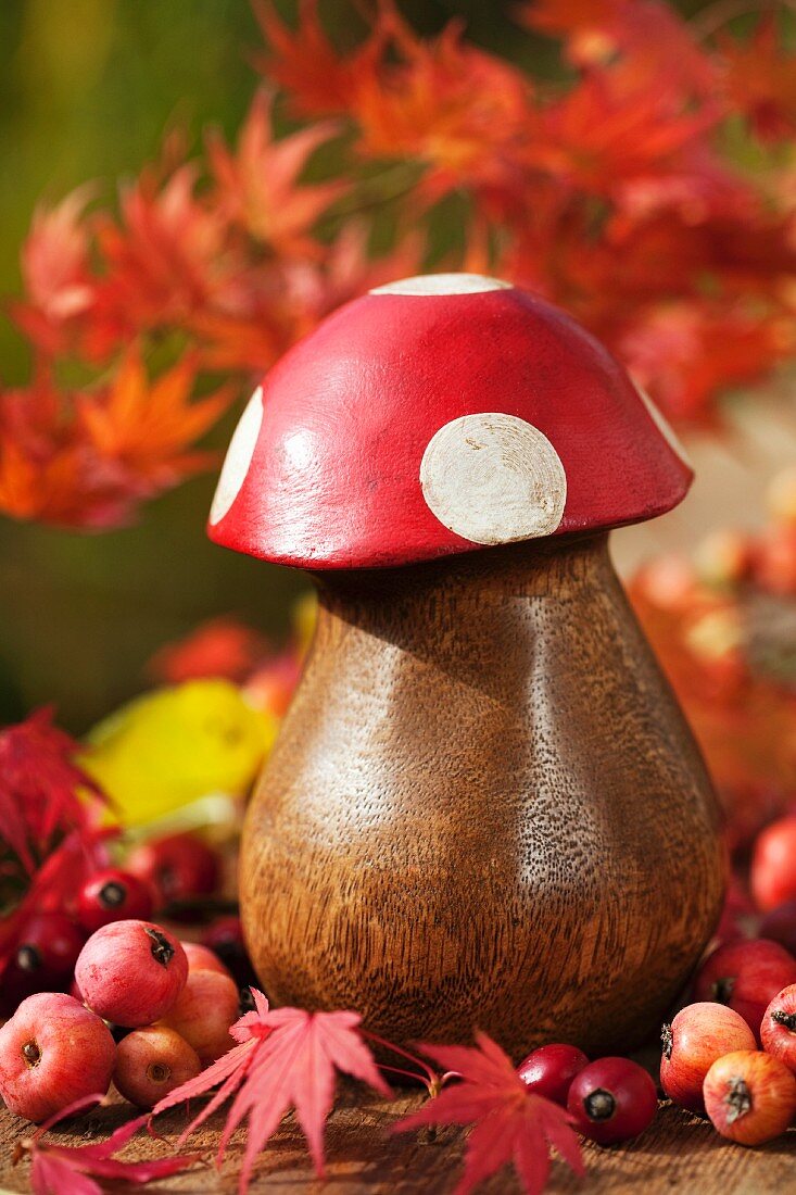 Wooden fly agaric among crab apples and Japanese maple