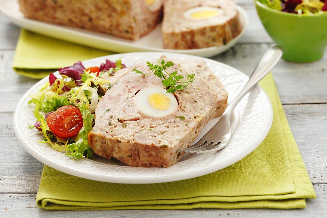 Meatloaf with egg and salad leaves