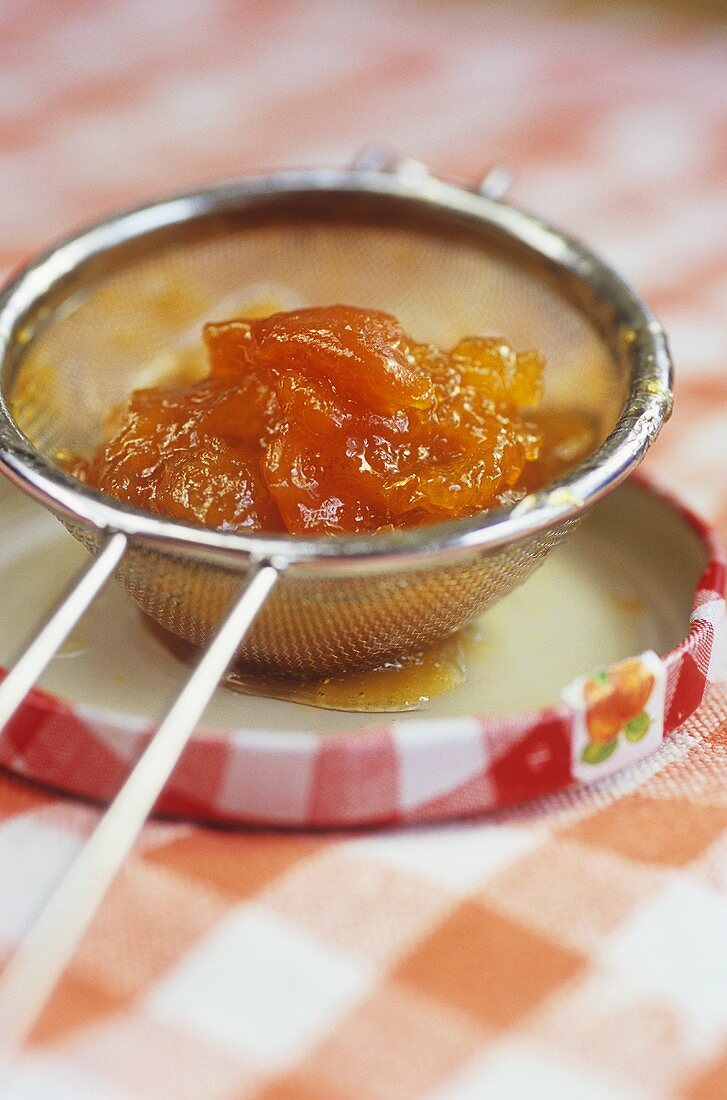 Apricot jam in a sieve