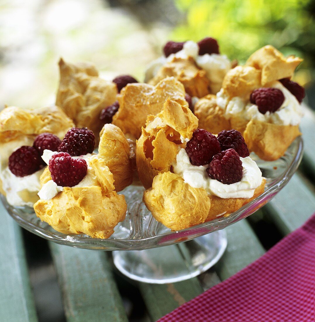 Profiteroles with cream and raspberries