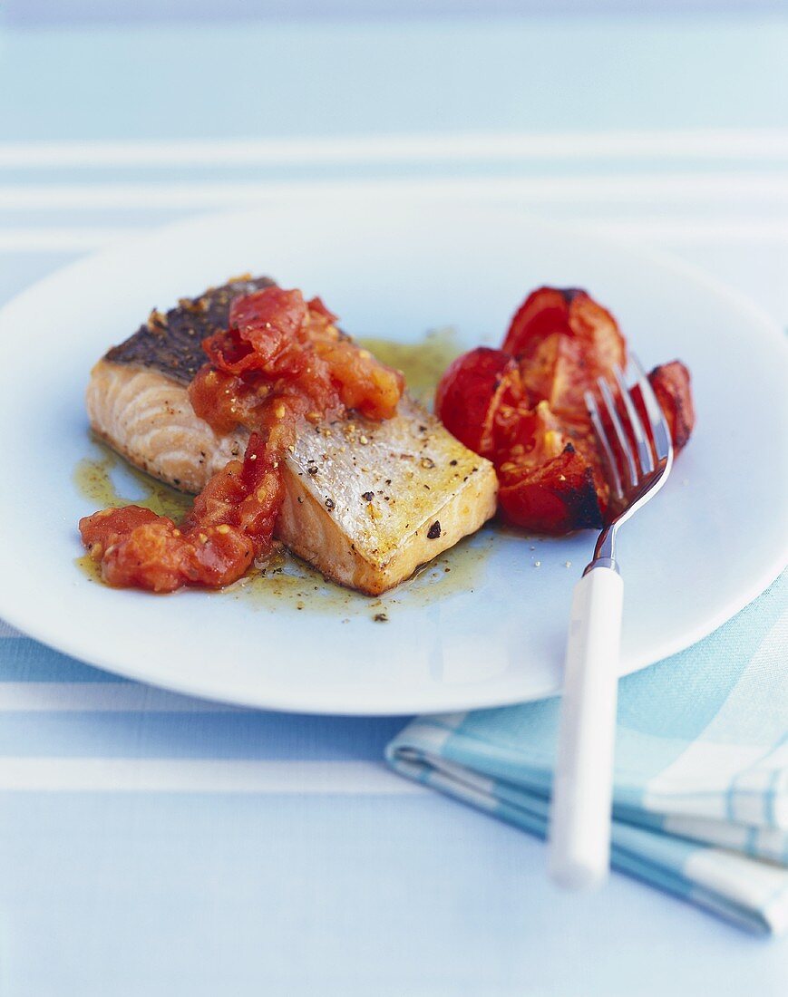 Fried salmon fillet with tomatoes