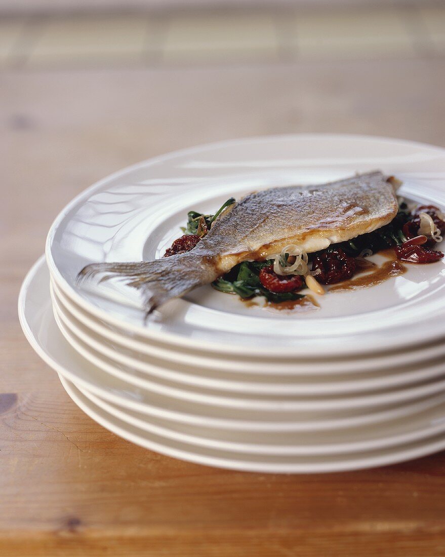 Sea bream with steamed rocket and pickled tomatoes