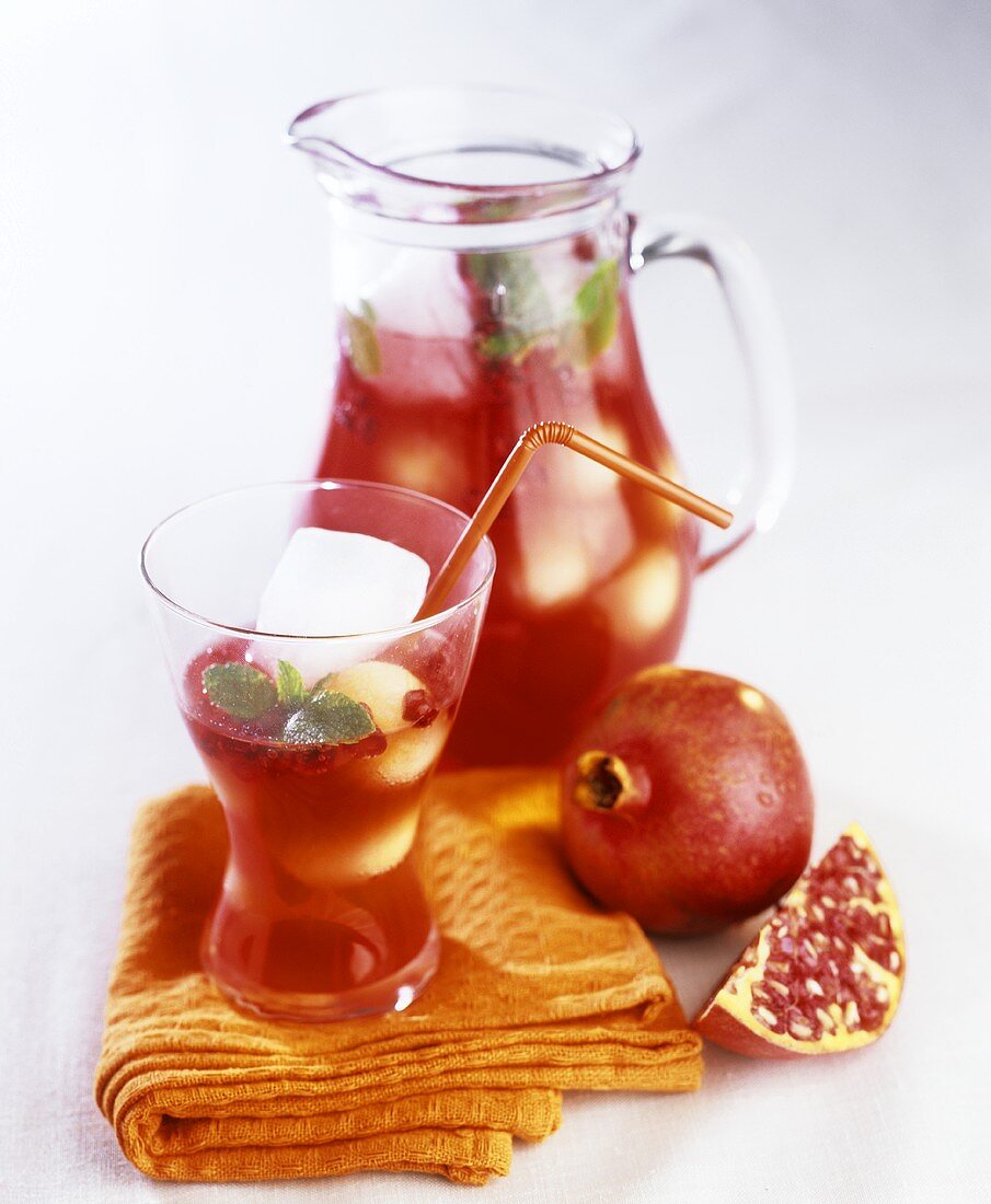 Still life with pomegranate juice and pomegranate