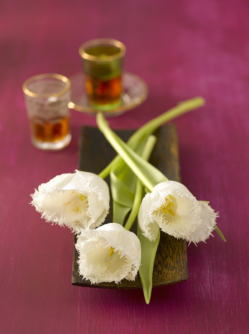 Still life with tulips and Middle Eastern tea glasses