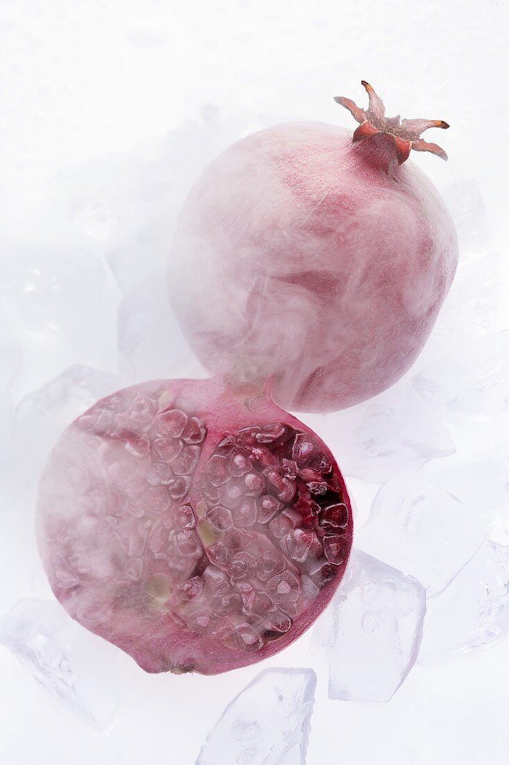 Frozen pomegranates with ice cubes