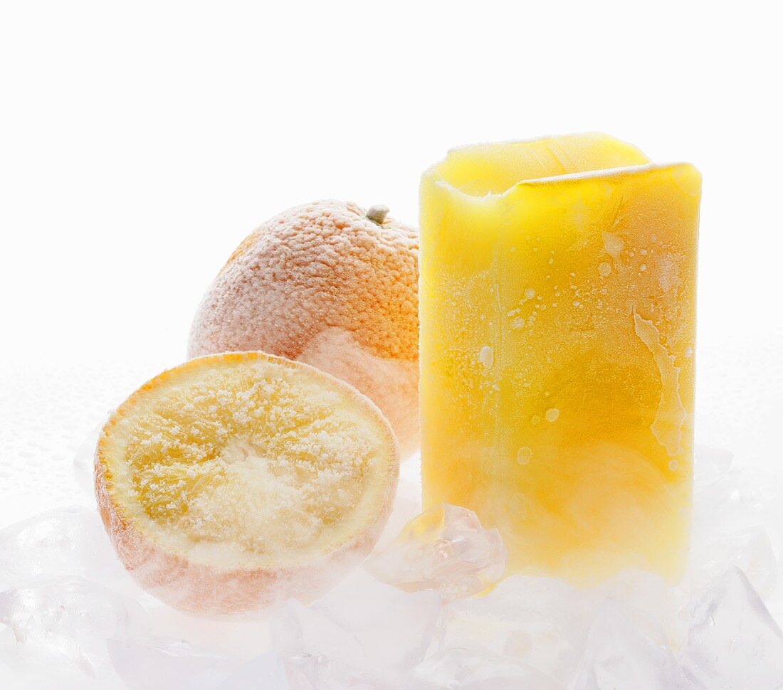 Frozen orange juice, oranges and ice cubes