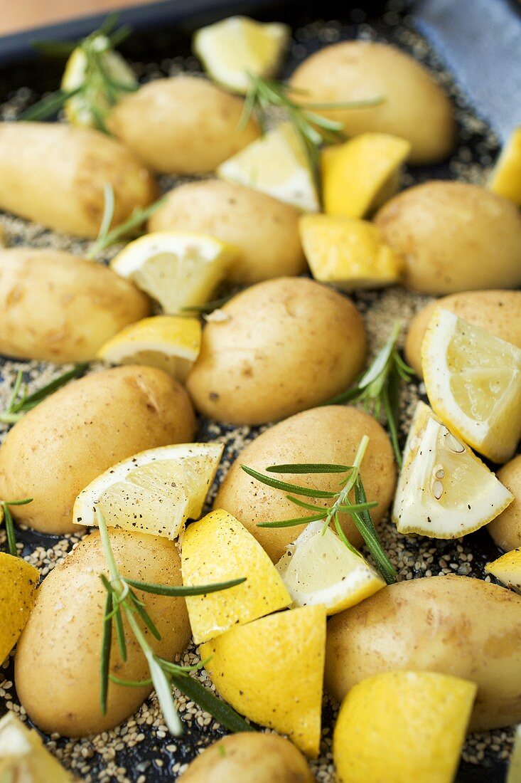 Sesame potatoes with lemon and rosemary on baking tray