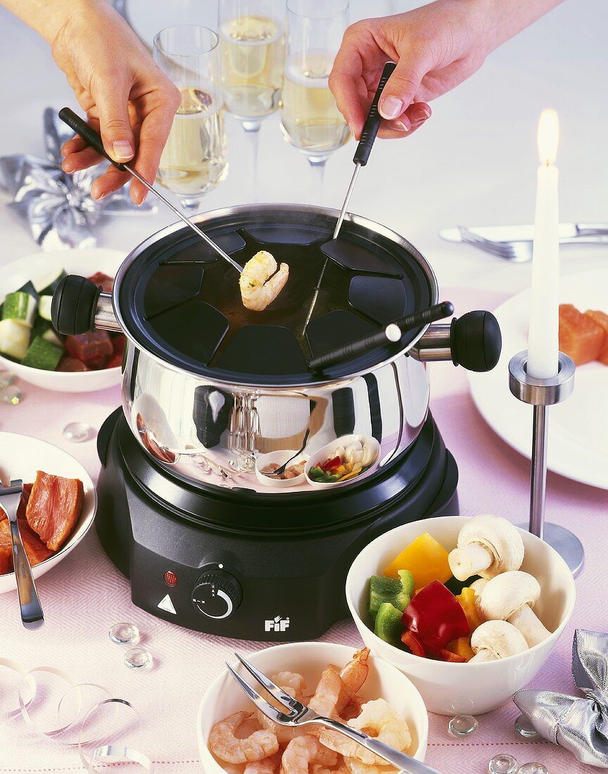 Fondue with shrimps, vegetables and meat