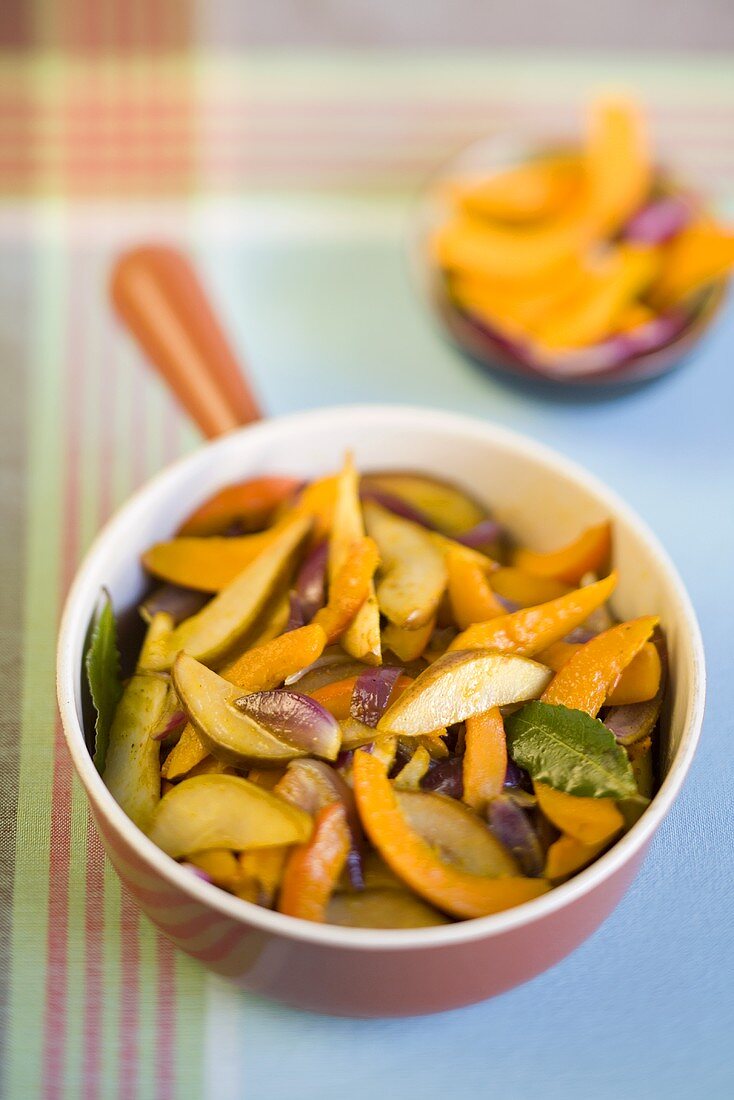 Roasted pumpkin slices with red onions and pear slices