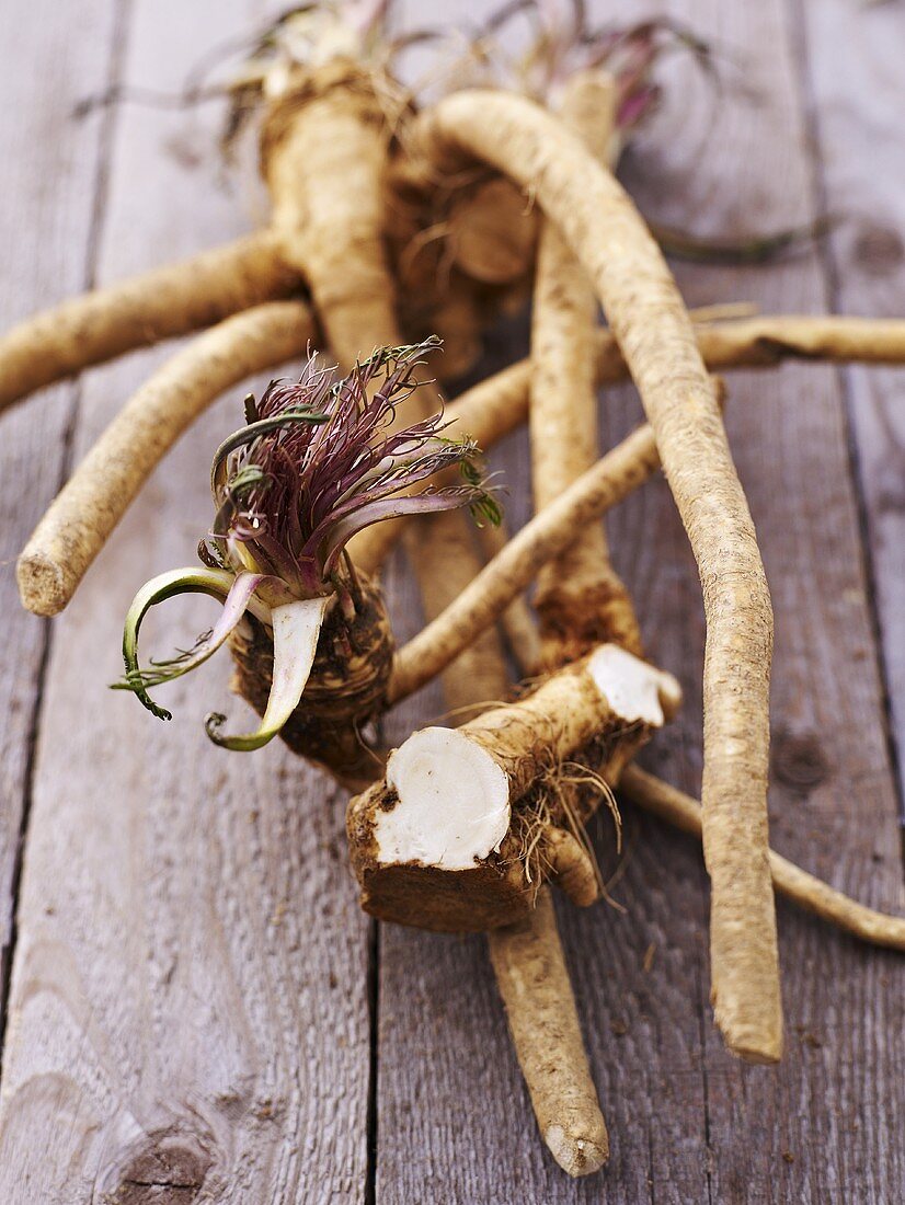 Horseradish roots on wooden background