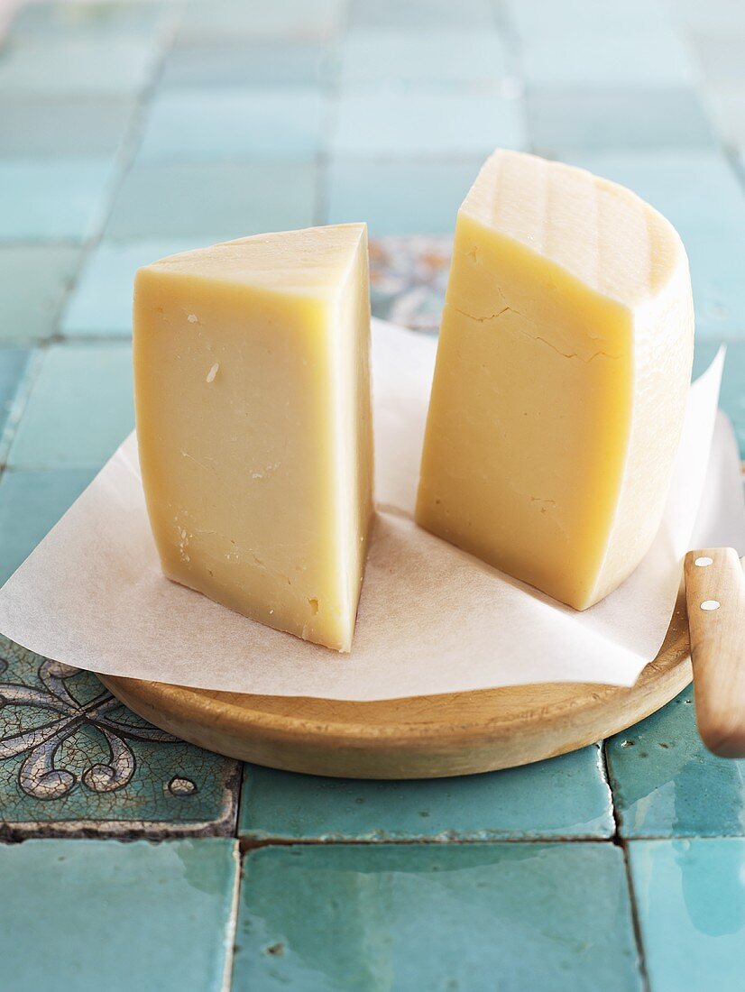 Pieces of Pecorino cheese on wooden board