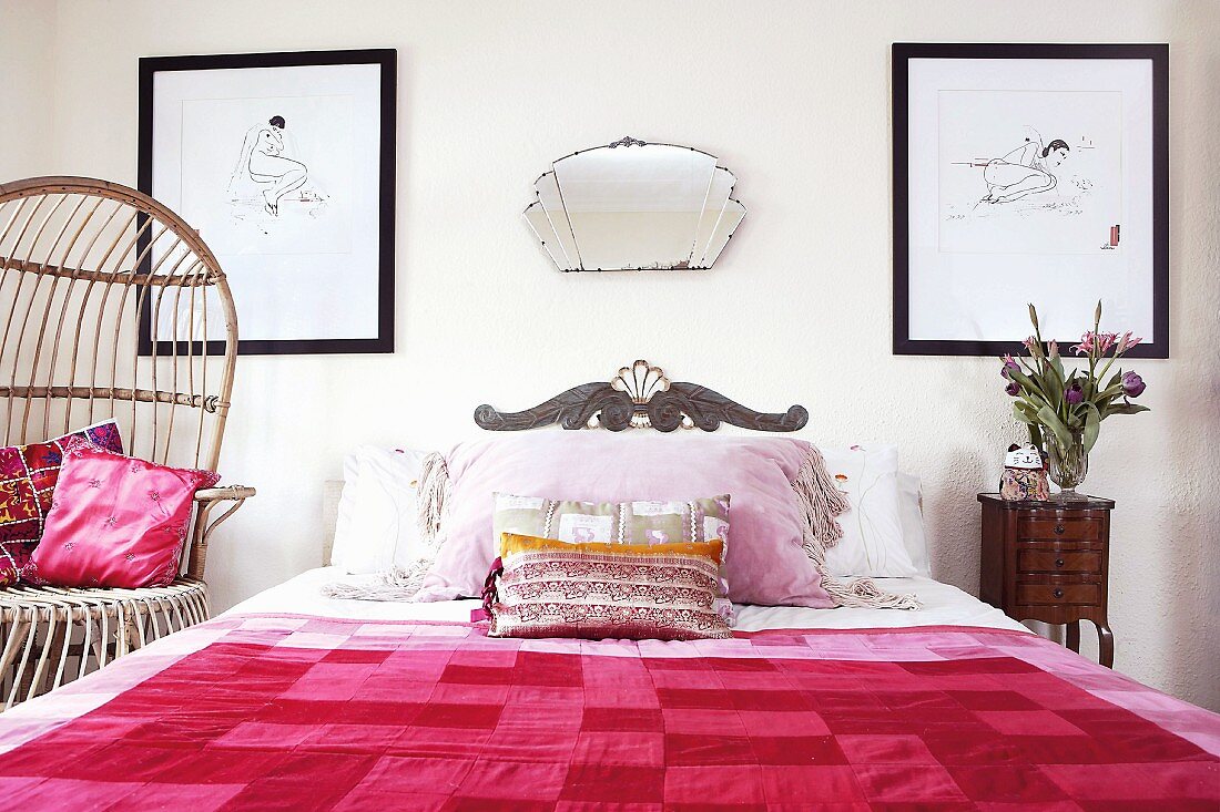 Bedroom with pictures on the wall and mirror