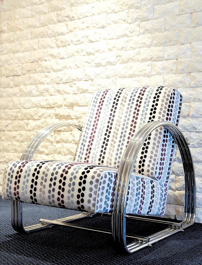 Upholstered chair with metal frame and spotted fabric