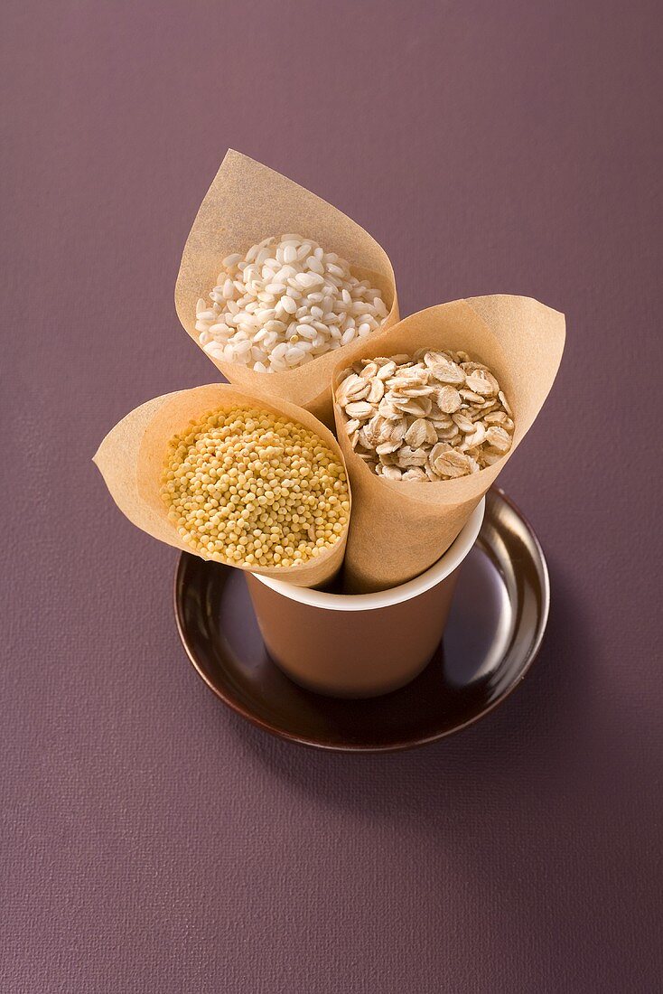 Millet, rice and rolled oats in paper bags
