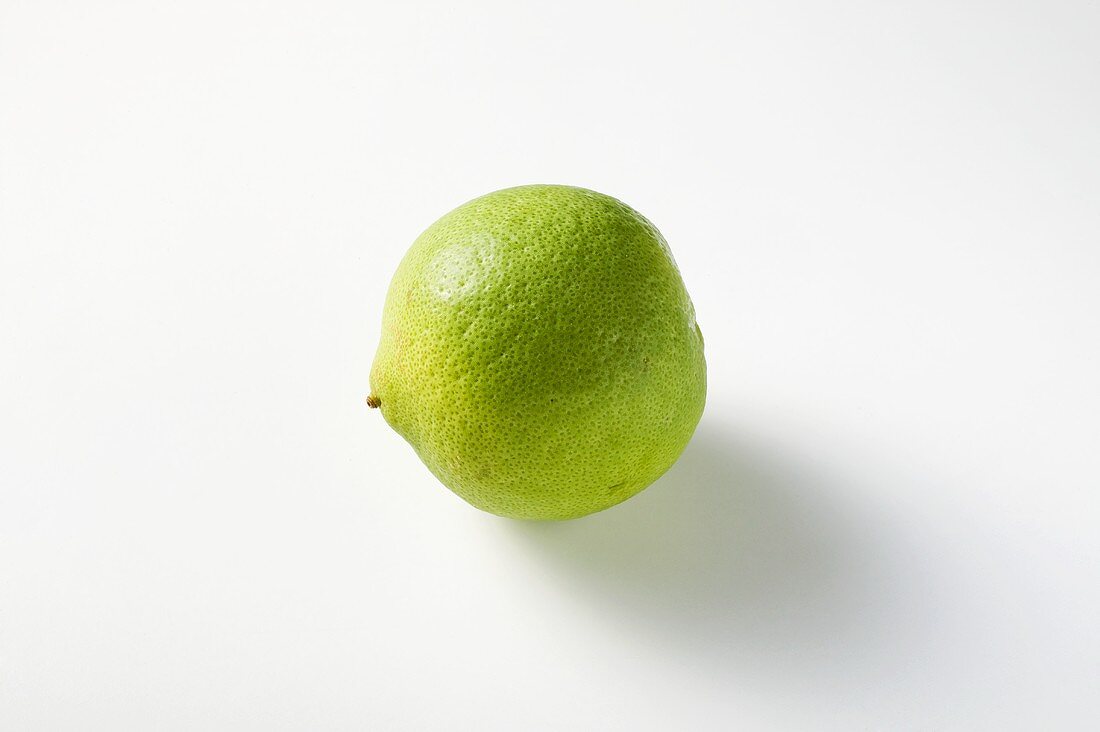 Whole Lime with Water Drops on a Black Background