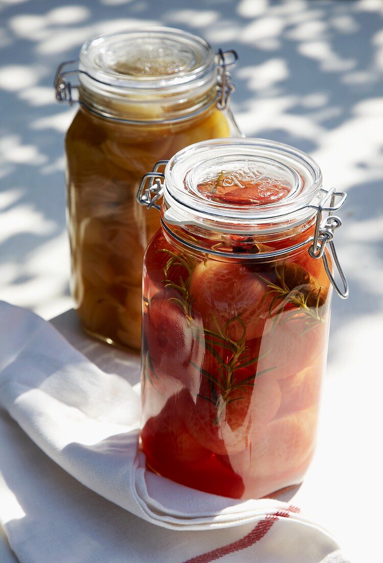 Bottled tomatoes and onions in two jars