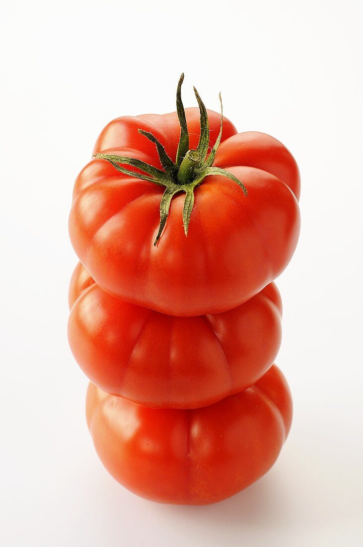Three tomatoes, stacked