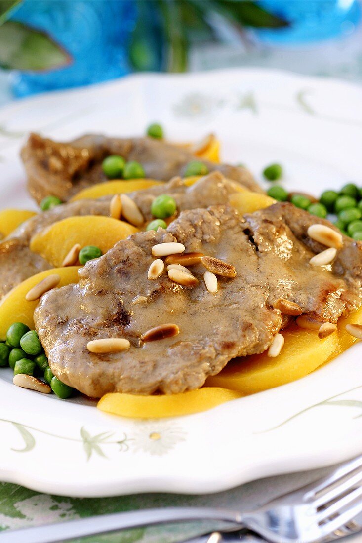 Veal with pine nuts, peaches and peas