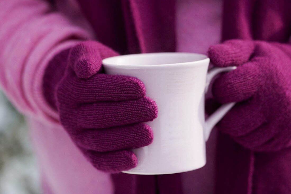 Hands holding a cup of hot chocolate