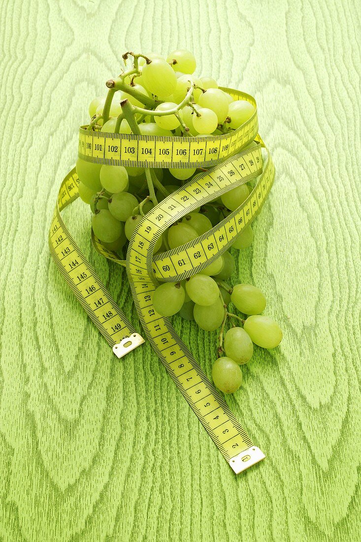 Green grapes with a tape measure